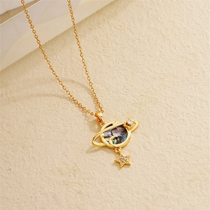Detail of 18K gold plated Saturn pendant with abalone shell heart and cubic zirconia star