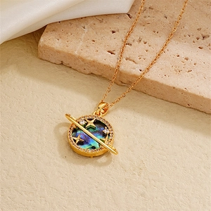 Detail of 18K gold plated heart planet necklace with abalone shell and zircon on silk