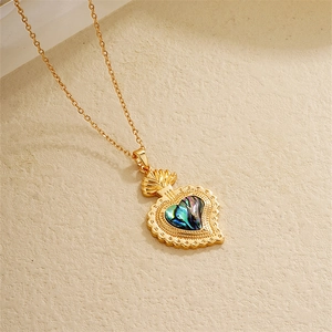 Macro detail of 18K gold plated heart necklace with colorful abalone shell inlay