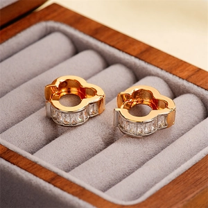 Luxurious 18k gold clover-shaped hoop earrings with baguette zircons in a jewelry box