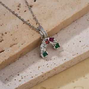 Dettaglio della collana con ciondolo a ferro di cavallo e gemme colorate su pietra naturale