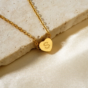 Gold heart pendant necklace with engraved letter S on a minimalist small ring chain