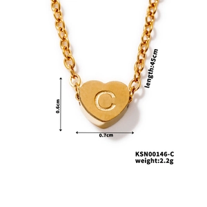 Close-up of golden heart pendant with letter C engraving and necklace dimensions details