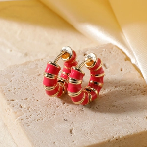 Retro gold hoop earrings with red striped enamel finish on a textured stone base