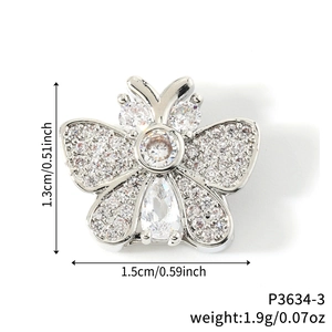 Detail of butterfly zircon charm showing dimensions 1.5cm by 1.3cm and 1.9g weight