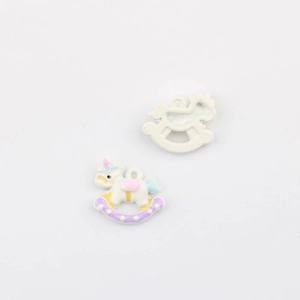 Detail view of colorful macaron enamel unicorn rocking horse pendants for DIY jewelry making