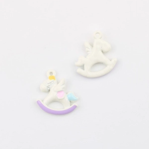 Macro shot of cartoon rocking horse pendants with colorful enamel coating for DIY jewelry