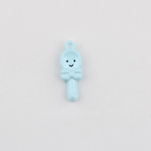 Detail of sky blue smiley face spoon charm with a 3D bow for DIY jewelry making