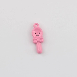 Close-up of pink enamel spoon charm with smiley face and bow for DIY jewelry making