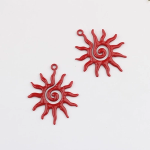 Macro detail of red alloy sunflower pendants with spiral design for DIY jewelry