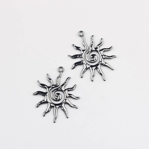 Macro view of sun-shaped alloy pendants with spiral center for DIY jewelry making