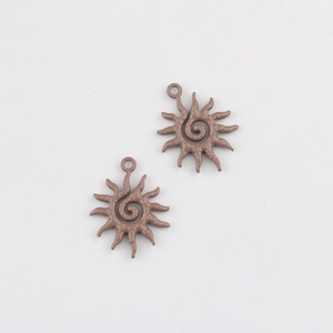Detail of two matte light brown sunflower alloy charms for DIY jewelry making and crafts