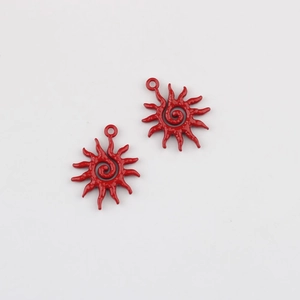 Detailed macro view of two red sunflower metal pendants for DIY jewelry making