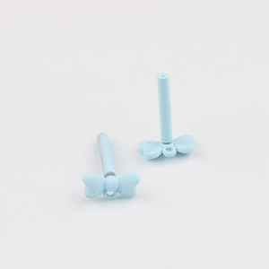 Detailed view of light blue matte bow-shaped DIY jewelry charms with long vertical rods