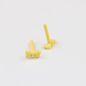 Detail of yellow bow-shaped alloy earrings with matte finish and connector loop