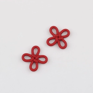 Detail shot of two red Chinese knot alloy pendants for DIY jewelry and crafts making