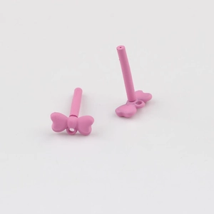 Detail of matte pink bow jewelry components for DIY earrings with steel posts