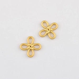 Macro detail of matte gold alloy Chinese knot pendants for DIY jewelry making