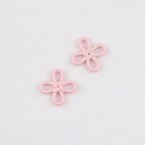 Detailed macro view of two pink matte Chinese knot flower pendants for jewelry making