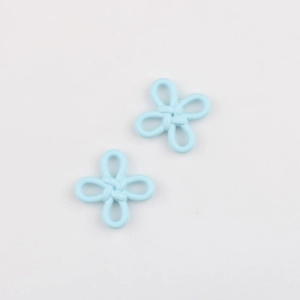 Macro shot of light blue matte alloy flower charms for DIY jewelry making accessories