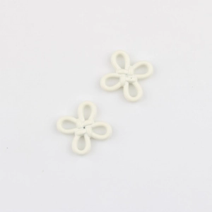 Close-up of minimalist cream white flower knot charms for DIY jewelry and clothing accessories