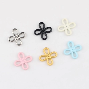 Close-up of alloy Chinese knot flower charms in six assorted matte and metallic colors