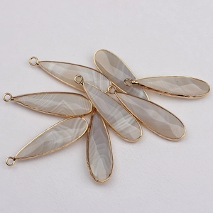 Natural agate teardrop pendants with gold plated edges and smooth striped textures