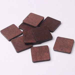Macro shot of square dark walnut wooden beads with pre-drilled holes for DIY jewelry