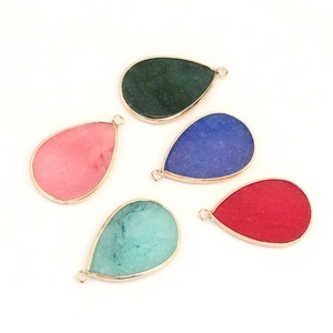 Detailed view of five colorful teardrop agate pendants with elegant gold metal edging