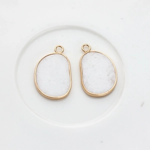 Detail of natural druzy stone charms with gold-plated edges for DIY jewelry making