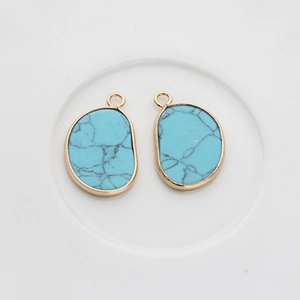 Detailed view of light blue irregular natural stone pendants with gold metal edges