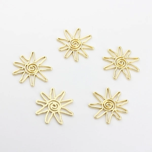 Detail of five gold geometric sunburst pendants with spiral center for DIY jewelry making