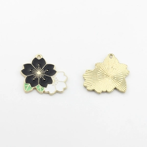 Macro detail of cherry blossom alloy pendant with dual-color drip oil and hanging hole