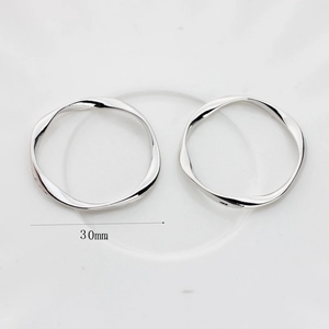 Detail shot of 30mm polished silver-tone twisted wave metal rings for DIY earrings
