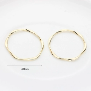 Detailed macro view of 40mm golden irregular wavy twisted circle charms for DIY jewelry making