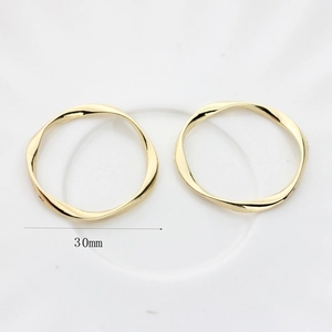 Detail of 30mm golden twisted circle earring pendants for DIY jewelry making