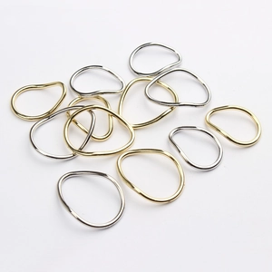Detailed view of irregular zinc alloy geometric loop pendants in gold and silver finishes