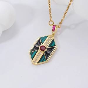 Vintage geometric gold necklace with green enamel and red zircon on a white background
