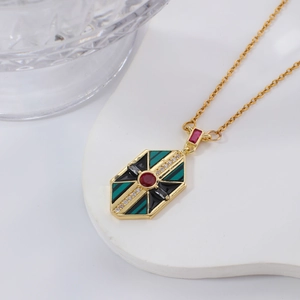 Vintage gold necklace with colorful zircon geometric pendant on white display tray