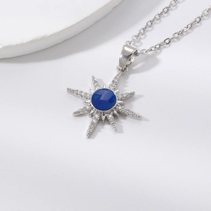 Elegant silver eight-point star necklace with a deep blue glitter stone and white zircons