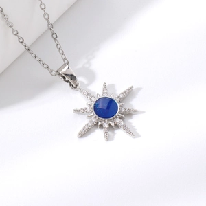 Star-shaped necklace with blue center stone and sparkling zircons in silver finish
