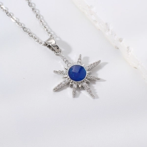 Elegant silver eight-pointed star necklace with blue gemstone and micro-pave crystals