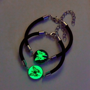Luminous butterfly charms on black adjustable wax rope bracelets glowing in the dark
