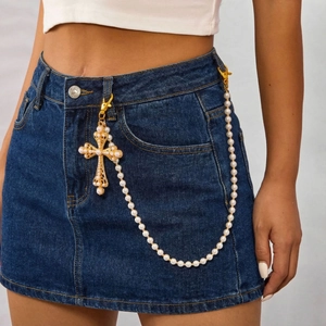 Punk hip-hop pearl waist chain with vintage golden cross pendant on blue denim skirt