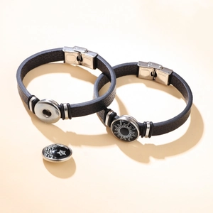 Detail of couple bracelets with stainless steel snap buttons and sun moon charms