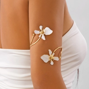 Bracelet de bras lotus doré élégant avec fleurs en émail blanc porté sur le bras