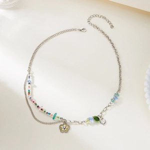 Detail of blue rhinestone butterfly layered necklace with colorful beads and star charm