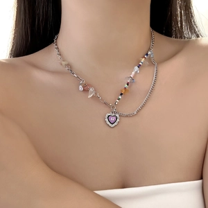 Detail view of double-layer necklace with blue rhinestones and purple heart pendant