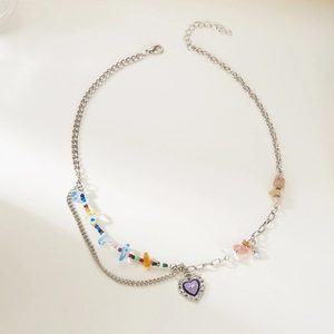 Detail of double-layer silver necklace with purple heart pendant and colorful beads