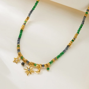 Detailed view of bohemian necklace with blue beads and celestial gold charms